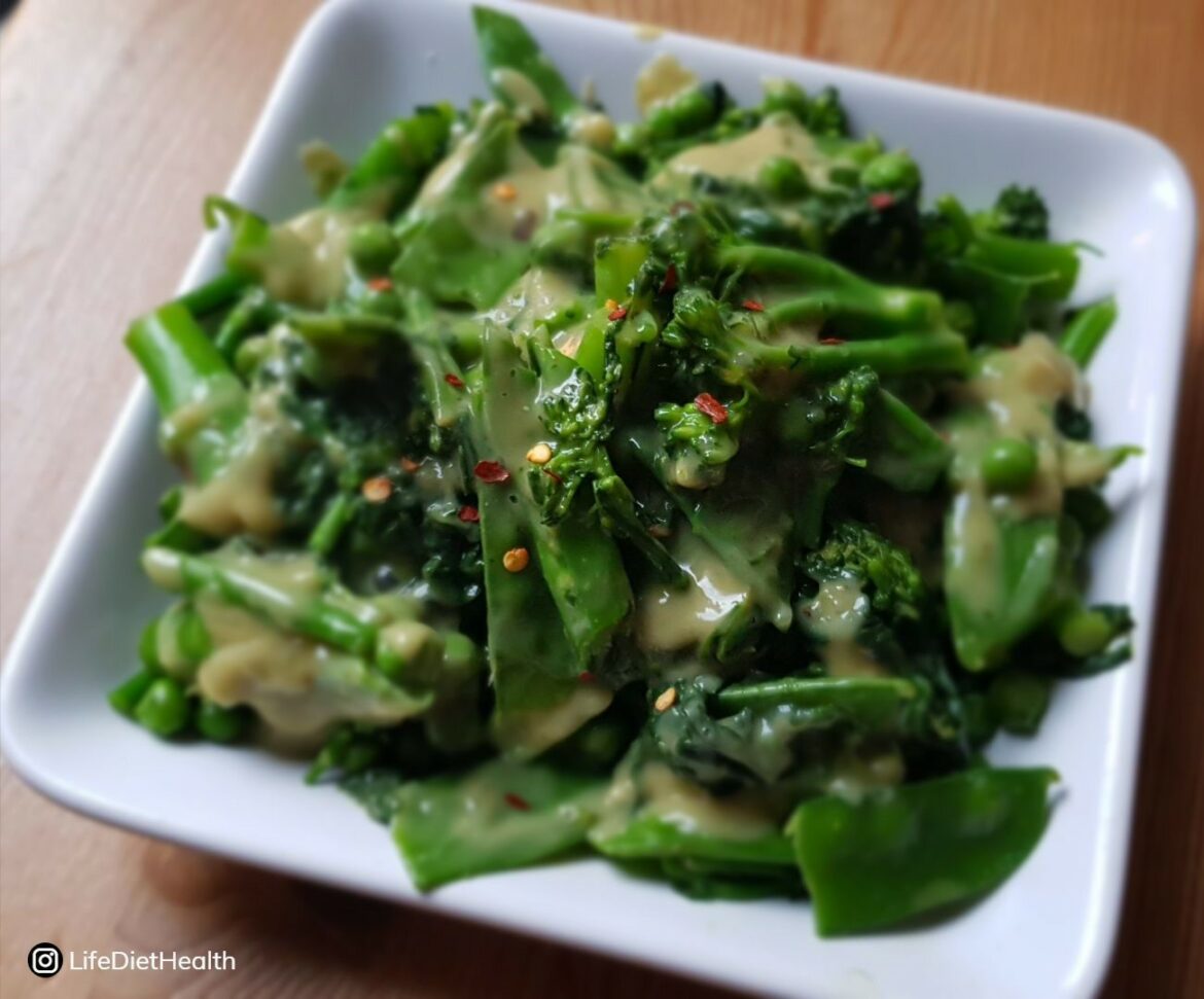 green veg in sauce on white plate